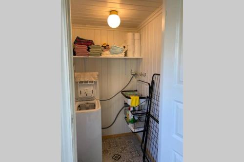 a laundry room with a washing machine and a washer at Huset ved evja in Ulefoss