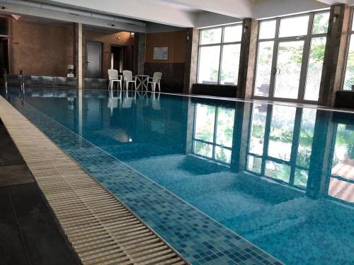 a large swimming pool with blue water in a building at Hotel Neptun in Vidin