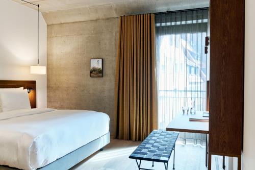 a hotel room with a bed and a window at Karl August - a Neighborhood Hotel in Nürnberg