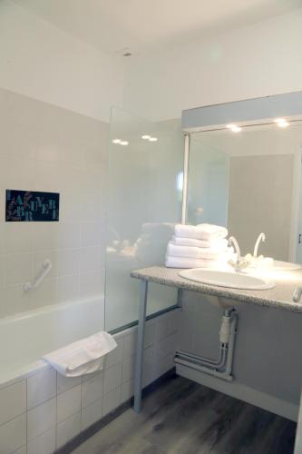 a bathroom with a sink and a shower and a mirror at HOSTELLERIE LA BRUYERE in Chalvignac