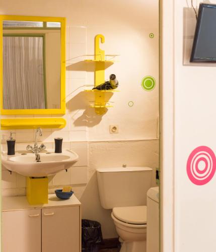 une salle de bain avec un lavabo, des toilettes et un miroir dans l'établissement La P'tite Bulle d'enFer, à Sabran