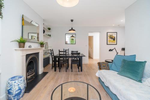 a living room with a couch and a table at Stylish flat with garden in Notting Hill in London