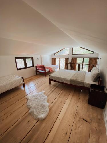 a bedroom with a bed and a rug on a wooden floor at Zicka plaza in Kraljevo