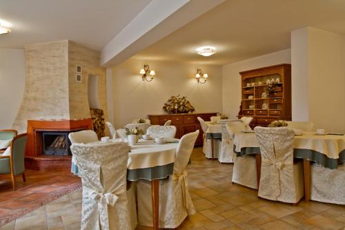 a dining room with tables and chairs and a fireplace at Willa Kominiarski Wierch in Zakopane