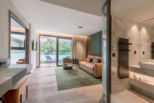 a living room with a couch and a table at Rivage Hôtel & Spa Annecy in Annecy