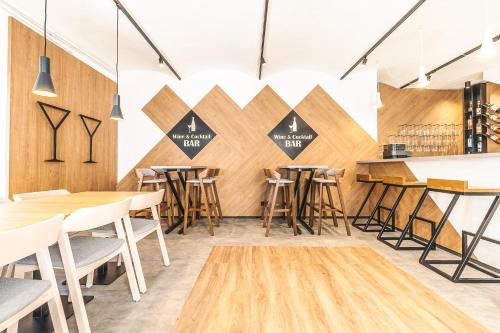 a restaurant with wooden walls and tables and stools at Spa Hotel Devin in Mariánské Lázně