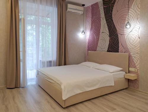 a bedroom with a white bed and a window at Nice and plesant apartments on Evropeyska st. in Poltava