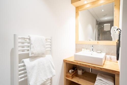 a bathroom with a sink and a mirror at La Ferme Du Lac in Thyez