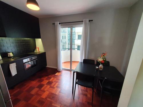 a kitchen with a table and a dining room at Santa Luzia's Pearl II - One Bedroom Apartment in Funchal