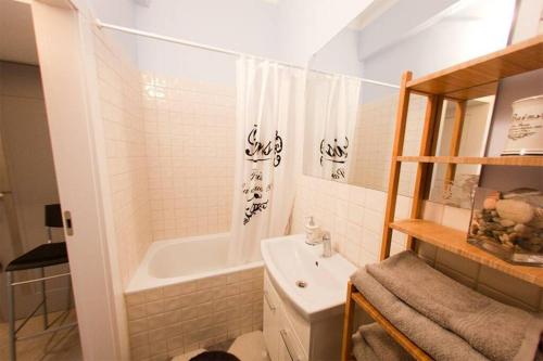 a bathroom with a tub and a sink and a shower at Apartament Podwale by Your Freedom in Warsaw