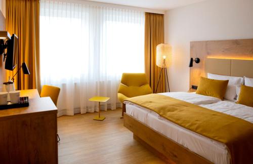 a hotel room with a bed and a chair at FischerS in Kassel