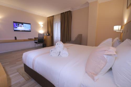 Postel nebo postele na pokoji v ubytování Mado Hotel
