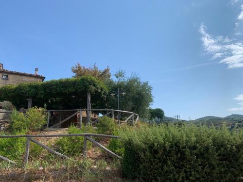 a farm with a fence in a field at La Dispensa-bio agriturismo in Lamporecchio