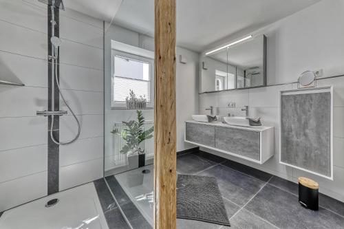 a bathroom with two sinks and a shower at Ferienhaus Leutner in Bodenmais
