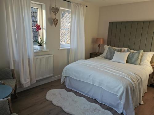 a bedroom with a large bed and a window at Seashell luxury apartment in Burnham on Sea