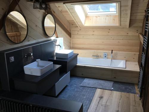 a bathroom with a sink and a bath tub at Chalet Tire-corde in Praz-sur-Arly