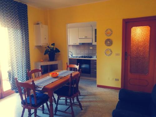 a kitchen with a dining room table and chairs at Elena Rooms in Campobasso