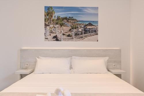 a bedroom with a bed and a picture of the ocean at Villa Boutique Tenerife in Adeje