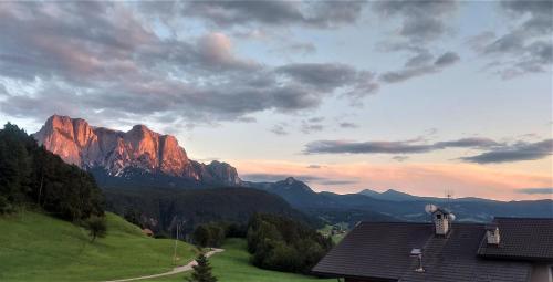 a view of a mountain range with a house at B&B Gasthaus Lieg in Castelrotto