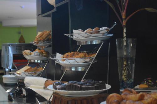 a bunch of different types of pastries on a table at Best Western Premier Accra Airport Hotel in Accra