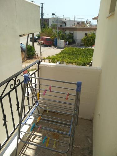 a chair on the balcony of a building at ΠΕΝΝΥ ΚΑΝΤΙΑ 1ος Ν 2 in Kandia