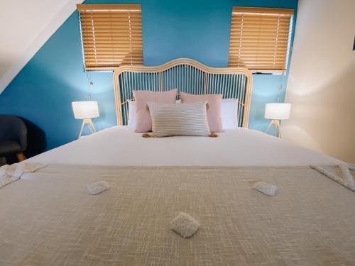 a bedroom with a large white bed with two lamps at Villa 5 Whitesands in Dunsborough