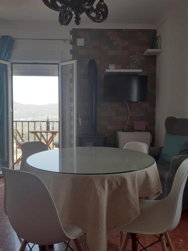a dining room with a table and chairs at Casa Rural Plaza Zahara Buenas Vistas in Zahara de la Sierra