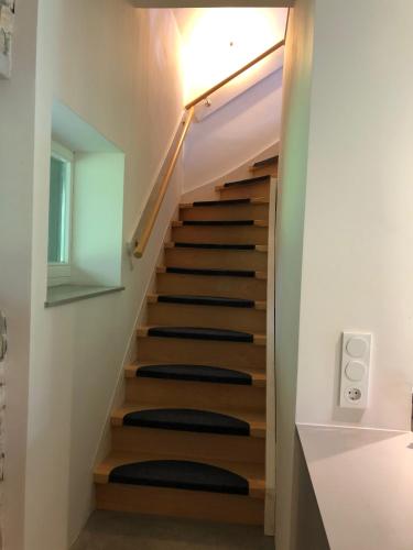 a staircase in a house with a black carpet at Apartment im Kranich Hotel in Hessenburg