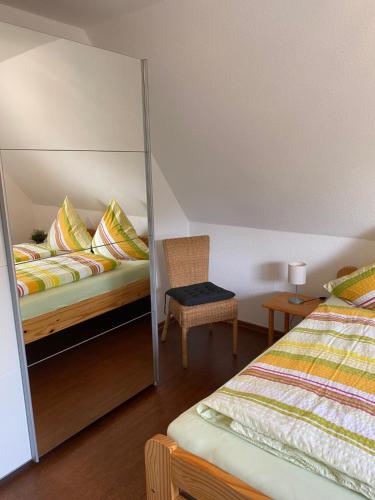 a bedroom with a mirror next to a bed at Wohnung auf dem Lande in Riepsdorf