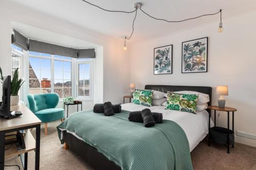 a bedroom with a bed and a desk and a chair at Ivydene - Beautiful Cottage, Stone Throw from Beach, Wonderful Sea Views in Saundersfoot