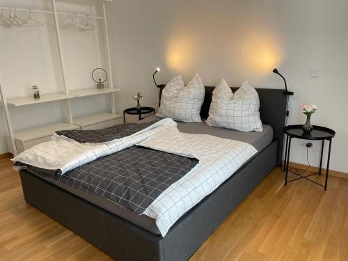 a bedroom with a large bed with pillows on it at Emerald Green Apartment in Offenbach