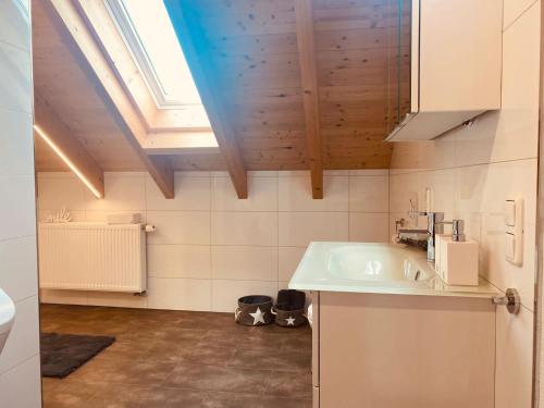a bathroom with a sink and a skylight at Gerolstein, Urlaub in der Eifel, Ferienwohnung mit Sauna in Gerolstein