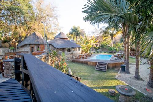 a backyard with a swimming pool and a house at BON Hotel Rustenburg in Rustenburg