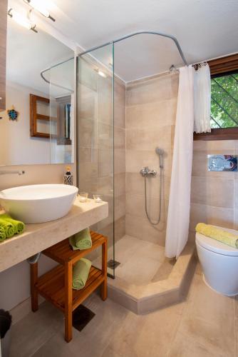 a bathroom with a sink and a shower at Bougainvillea in Gaios