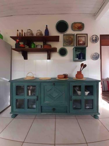 a green cabinet in a room with plates on the wall at VILLA COIMBRA in Lauro de Freitas
