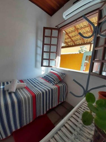 a bedroom with a bed and a window at VILLA COIMBRA in Lauro de Freitas