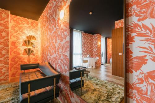 a dressing room with orange wallpaper and a mirror at Collini Rooms, WorldHotels Crafted in Milan