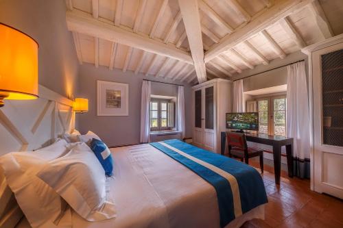 A bed or beds in a room at Borgo Scopeto Wine & Country Relais