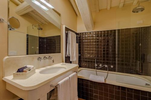 a bathroom with a sink and a tub at Borgo Scopeto Wine & Country Relais in Vagliagli