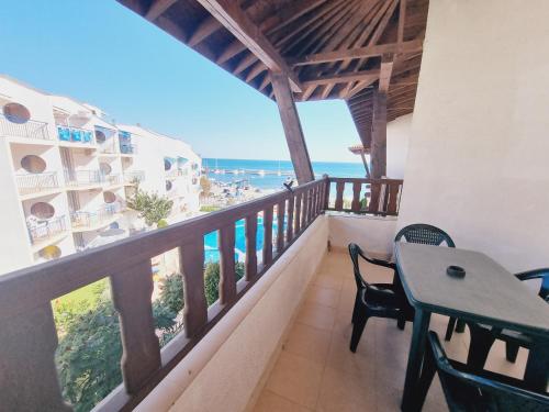 a balcony with a table and chairs and the ocean at Top Complex in Sveti Vlas