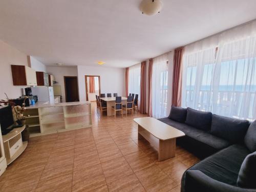 a living room with a couch and a table at Top Complex in Sveti Vlas