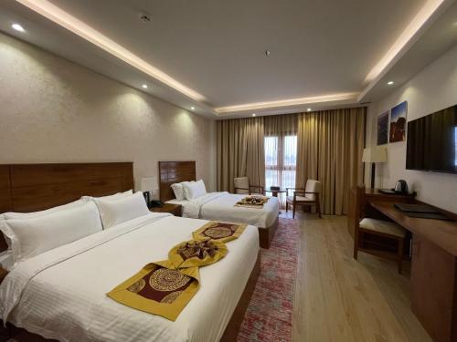 Postel nebo postele na pokoji v ubytování Alsahwa Hotel