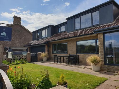 an external view of a house with a table outside at Eastwatch guesthouse in Berwick-Upon-Tweed