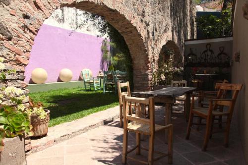 a patio with a table and chairs in a yard at La Casa del Atrio in Querétaro