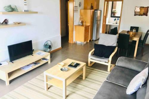 a living room with a couch and a table at Apartamento Vista do Mar A in Ribeira Quente
