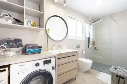 a laundry room with a washer and dryer at Seaview 3 bedroom Kings Road Penthouse in Paphos City
