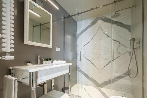 a bathroom with a sink and a shower at Florence Luxury Apartment al Duomo by Mmega in Florence