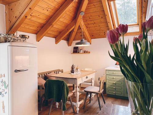 a kitchen with a table and a refrigerator at Villa Rosa in Bad Gastein