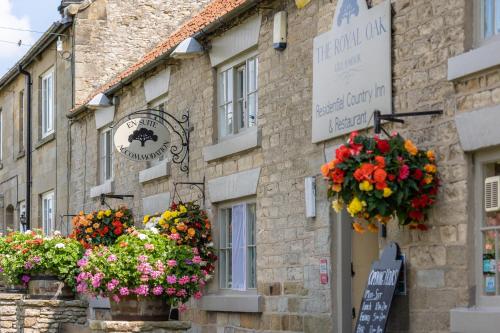 a building with flower baskets on the side of it at The Royal Oak in Gillamoor