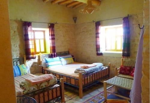 A bed or beds in a room at Kasbah Dar Talouste